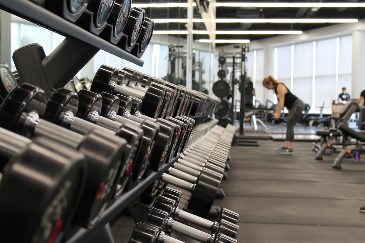 Professional woman doing hip thrust exercise in a modern hotel fitness center