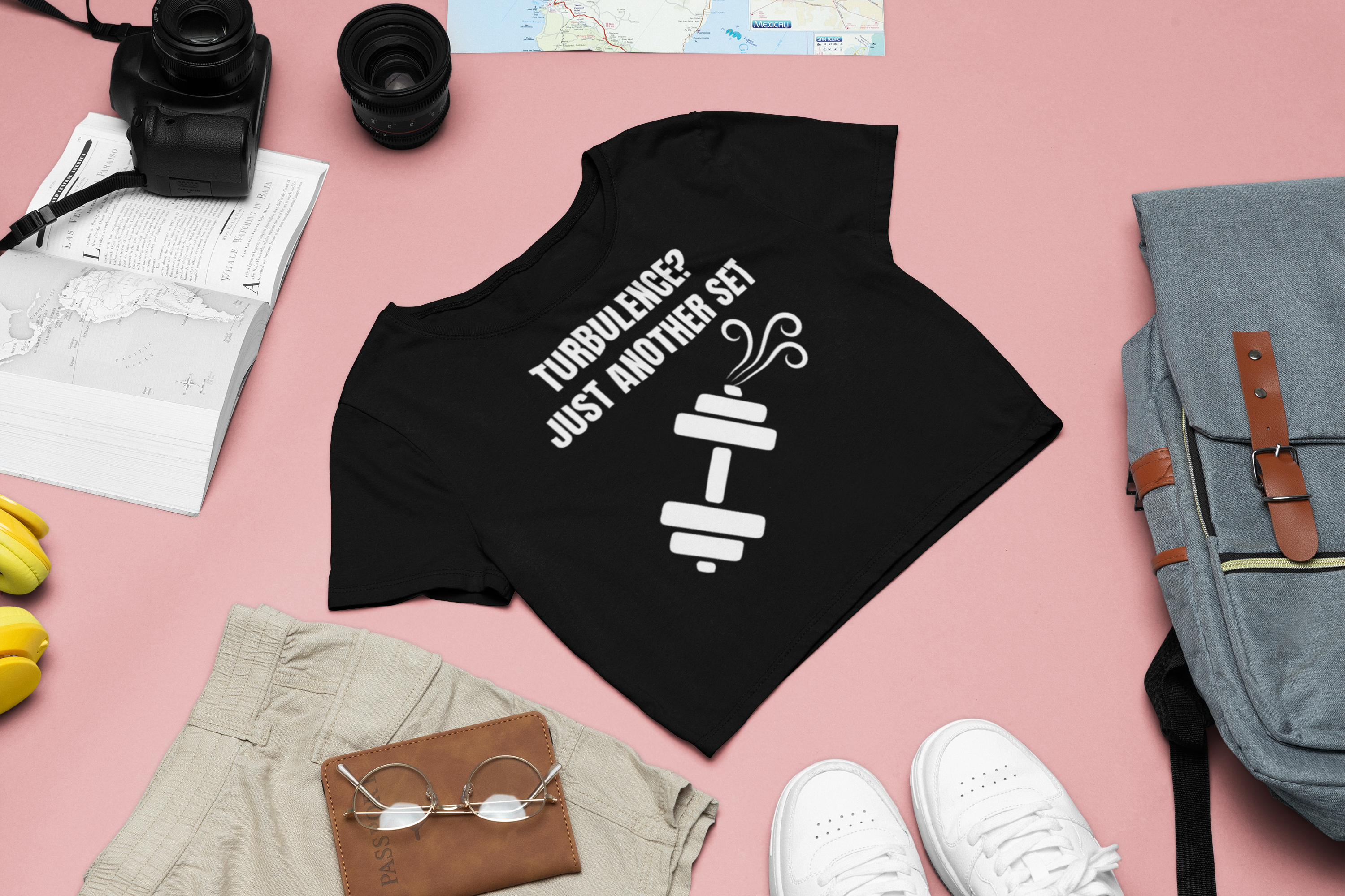 Travel capsule wardrobe flat-lay with D&H women's crop top, passport wallet, and sneakers for the hotel gym