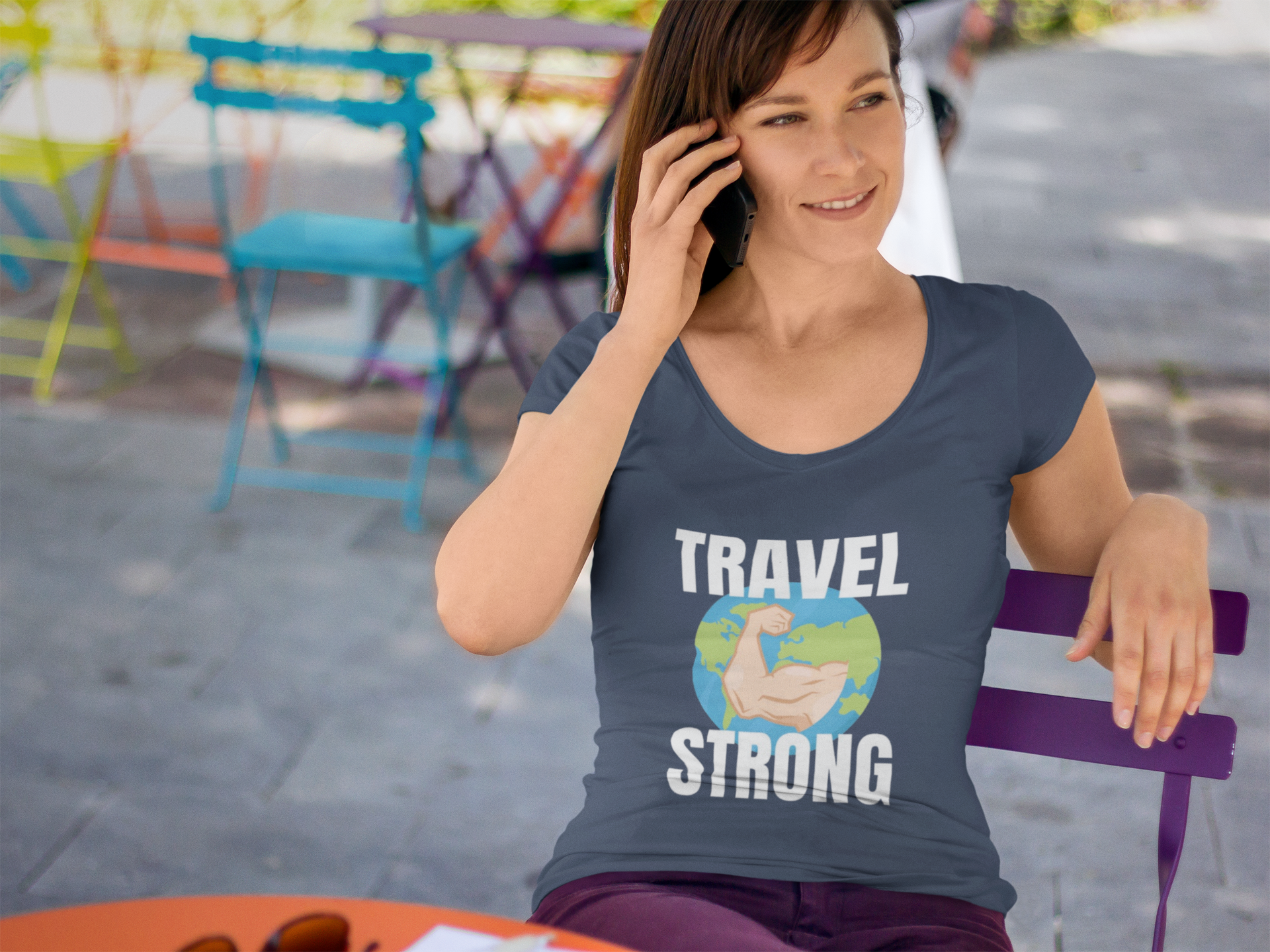 Road warrior in the Travel Strong Unisex Classic Tee in Navy at an outdoor café — layover-ready, wrinkle-resistant travel apparel