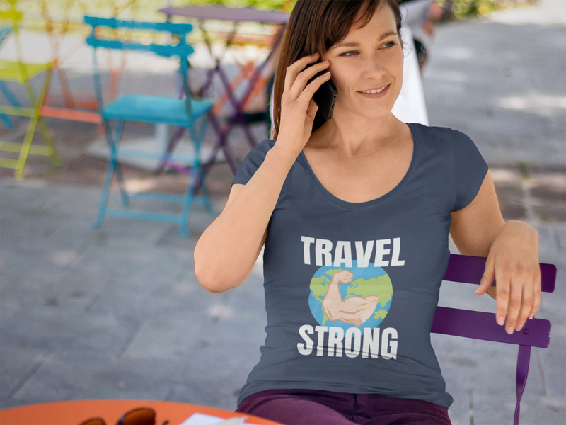 Road warrior in the Travel Strong Unisex Classic Tee in Navy at an outdoor café — layover-ready, wrinkle-resistant travel apparel