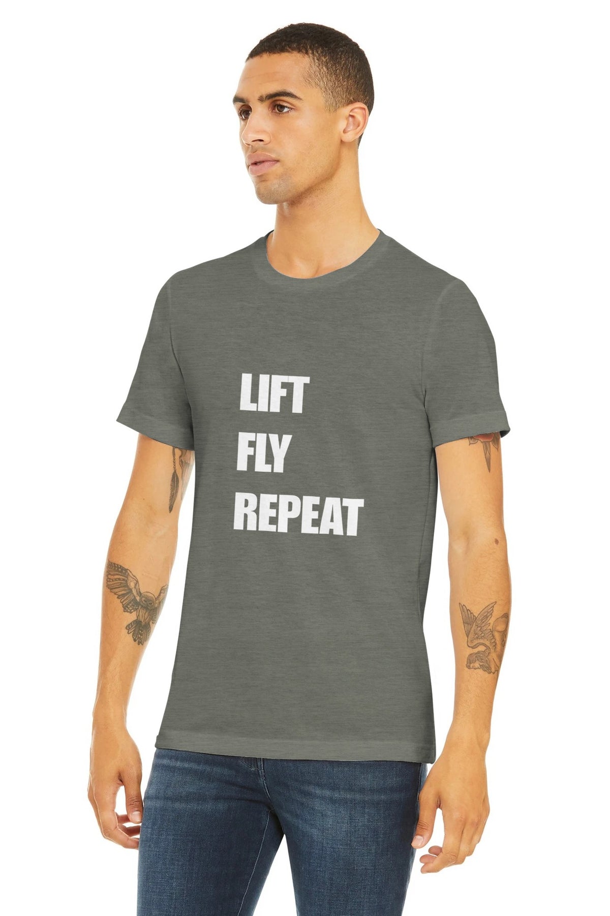 Lift Fly Repeat unisex triblend tee for travelling professionals, printed with a laurel-wreath crest with crossed dumbbells, aviator wings and a LIFT. FLY. REPEAT. ribbon — product photo 17 of 19