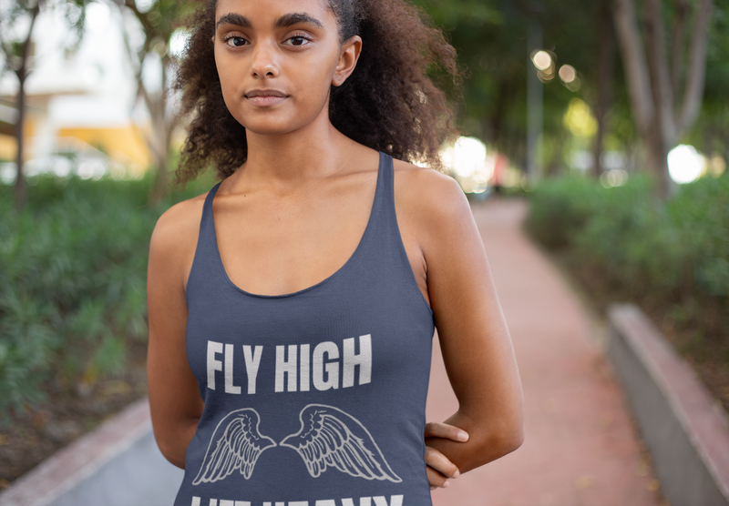 Woman wearing The Layover Racerback Tank in Vintage Navy while walking through a park | Travel fitness lifestyle | Dumbbells & Hotels