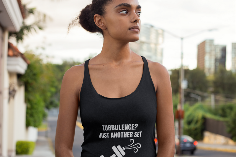 Female travel professional wearing wrinkle-resistant Turbulence racerback tank on urban street - designed by pilots