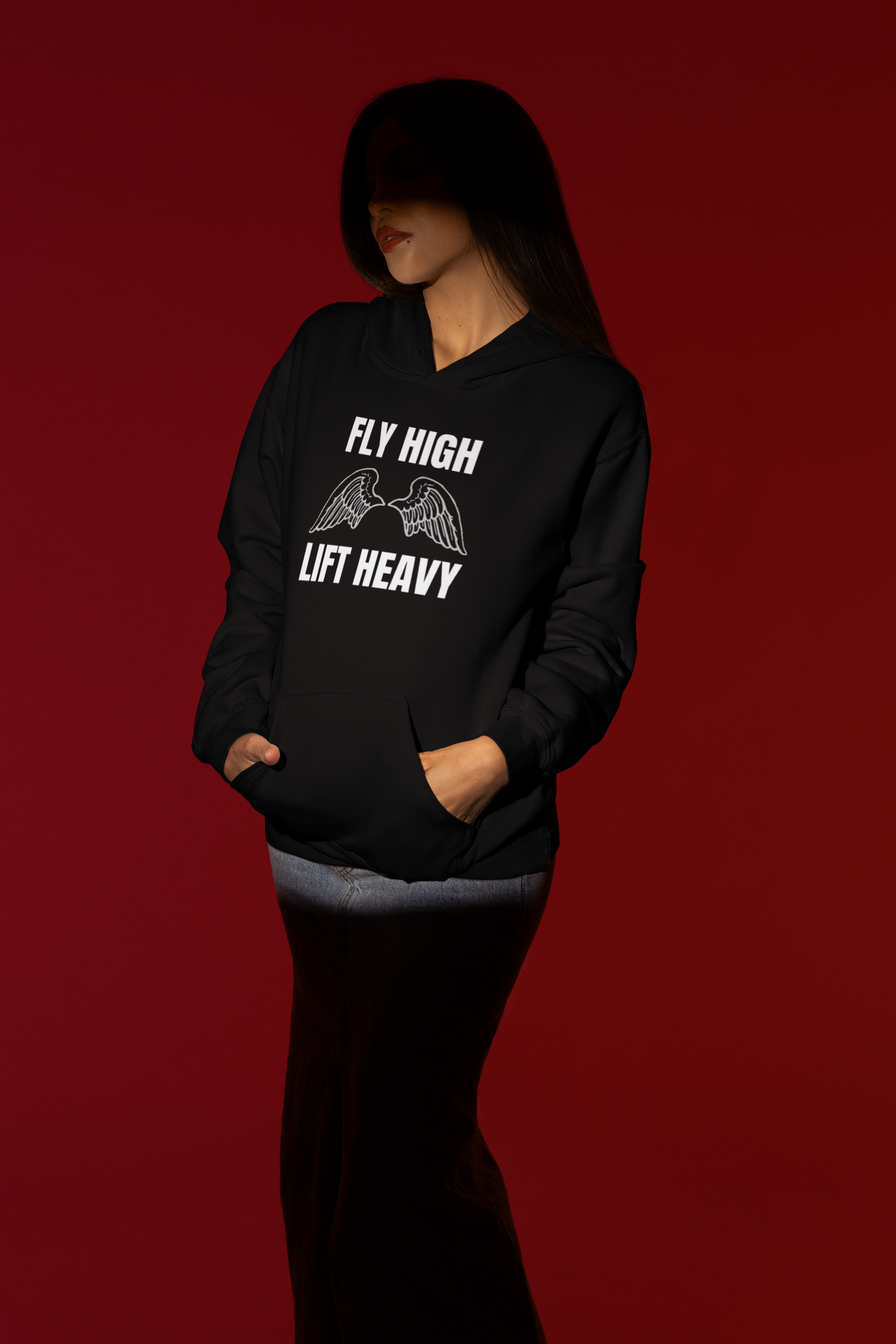 Spotlight portrait of female road warrior in black Fly High Lift Heavy hoodie — designed by pilots for layover-ready comfort
