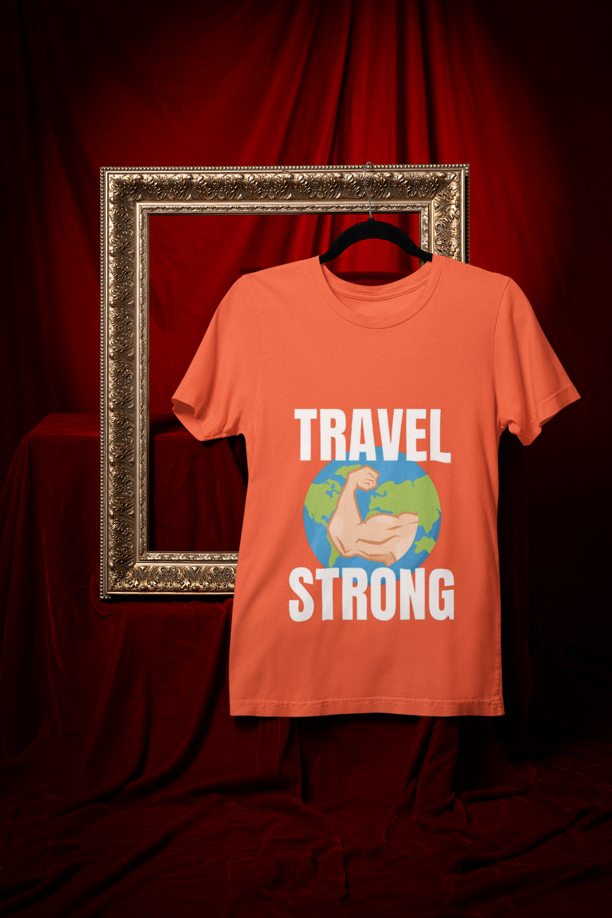 Travel Strong unisex t-shirt in Orange hanging in vintage frame — designed by pilots for the hotel gym