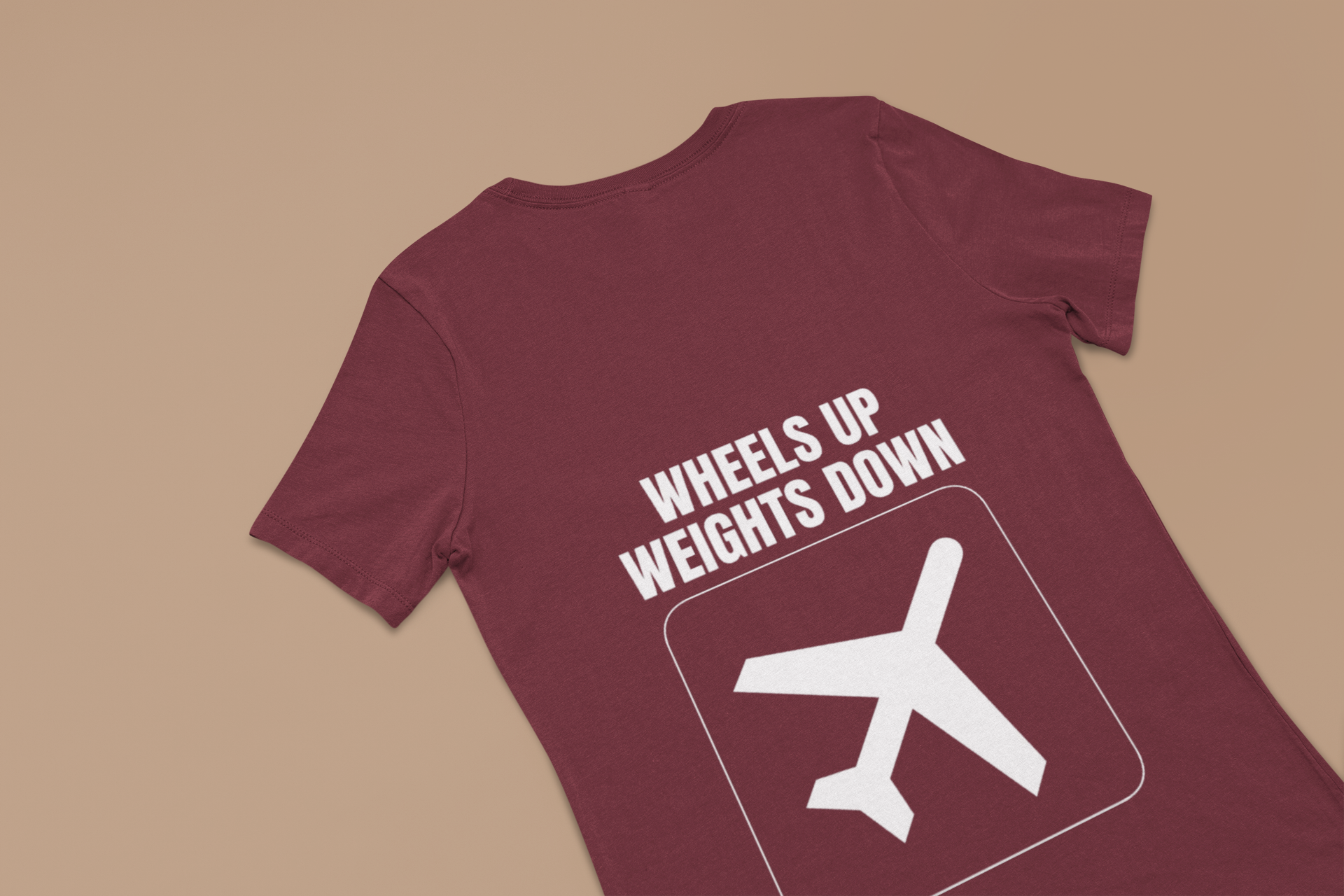 Maroon Wheels Up Weights Down unisex travel gym t-shirt flat-lay, layover-ready technical tailored fit for road warriors