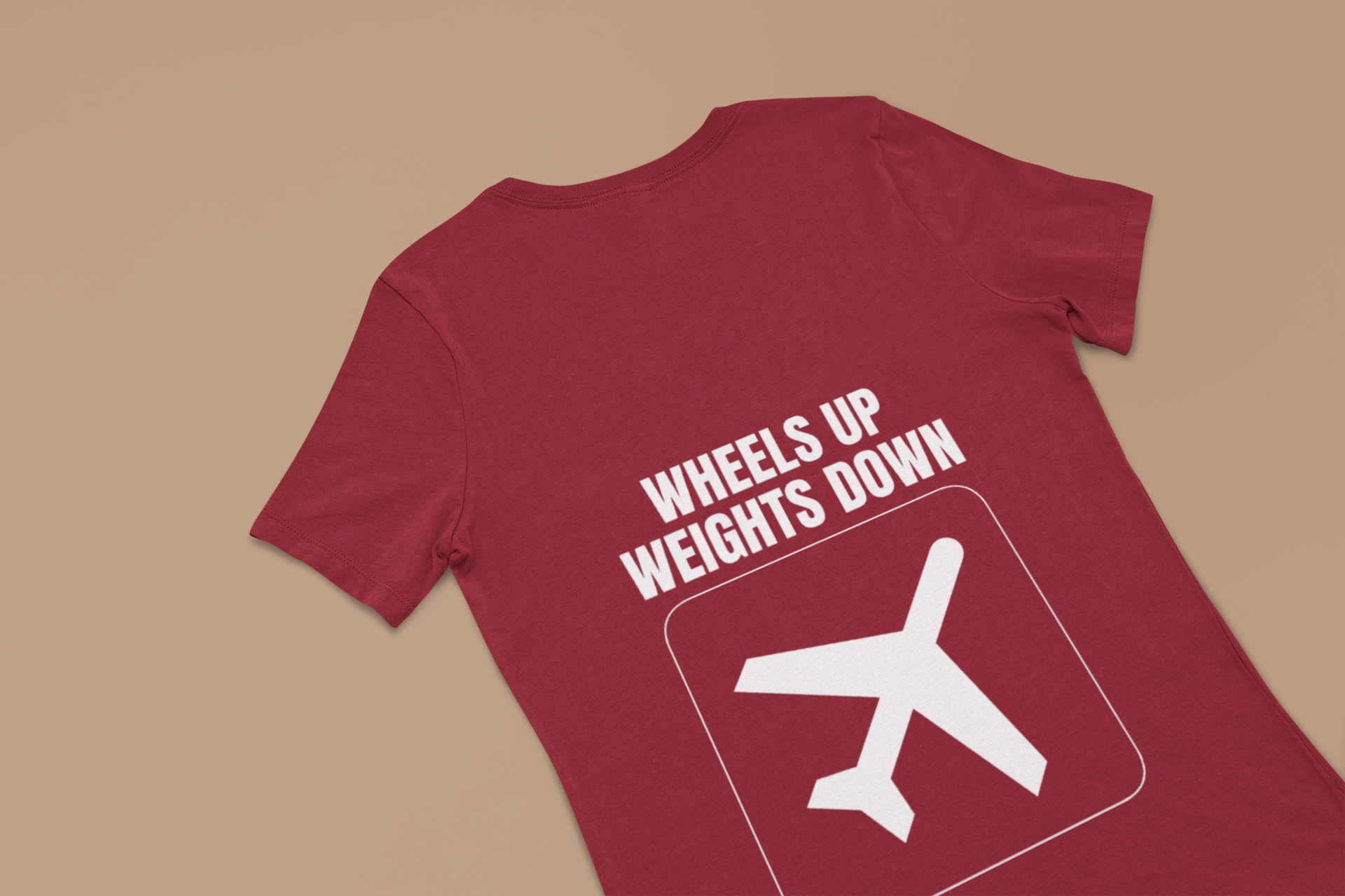 Cardinal red Wheels Up Weights Down unisex travel gym t-shirt flat-lay, designed by pilots for the hotel gym lifestyle